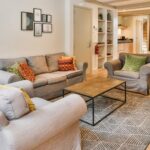 Living room of a fully furnished apartment in Port Moresby with modern furniture, natural lighting, and open-plan dining area – ideal for expats and diplomats
