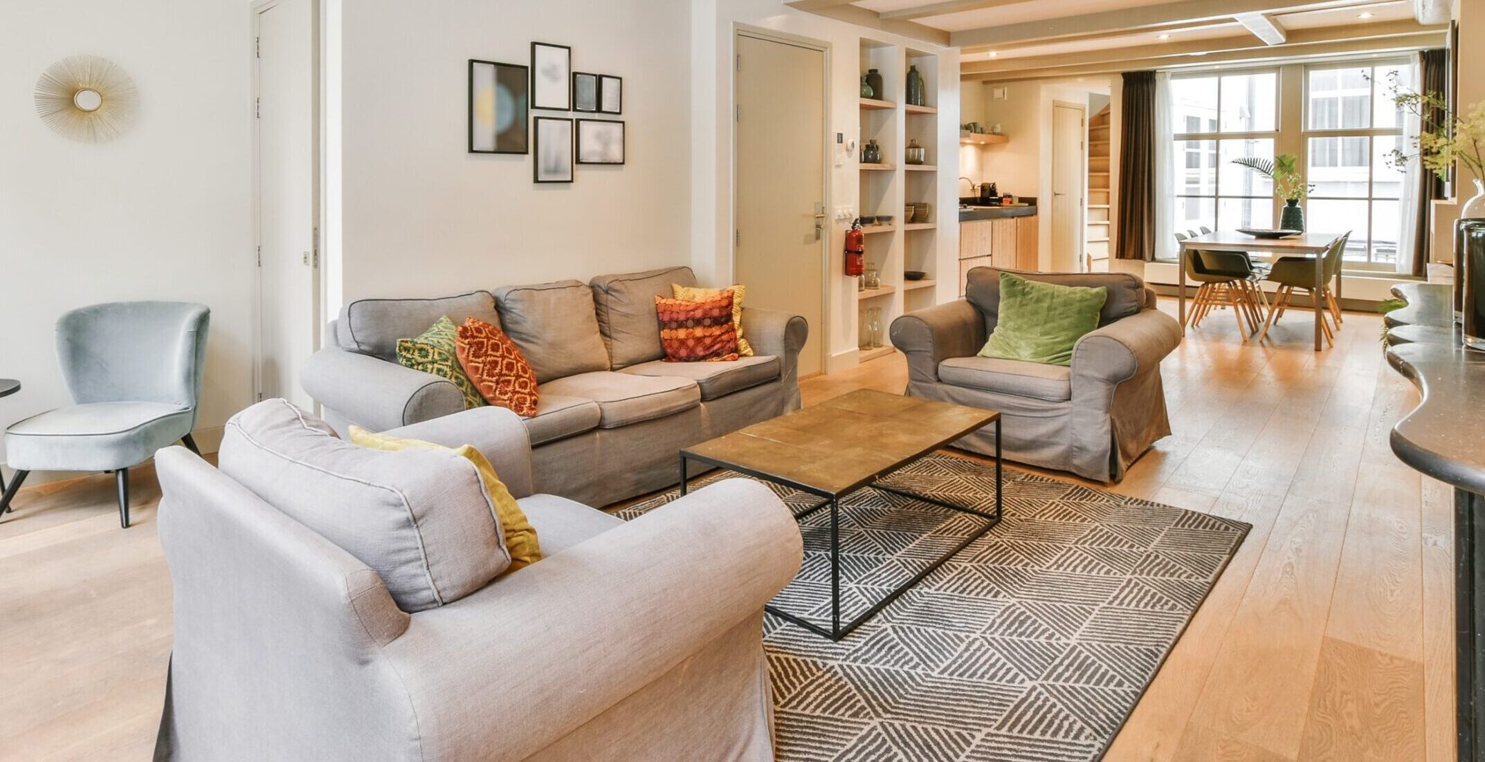Living room of a fully furnished apartment in Port Moresby with modern furniture, natural lighting, and open-plan dining area – ideal for expats and diplomats
